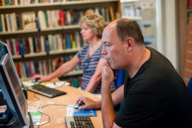 Visitors using library PCs in Canford Cliffs, Poole.