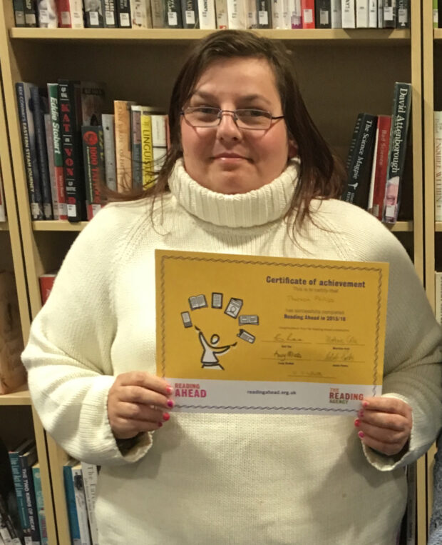 Theresa with her completion certificate. Photo credit: The Reading Agency