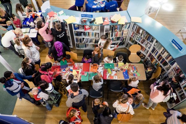 Photo looking down on children having lunch at the library.