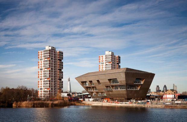 Photo of the outside of a library which overlooks some water.