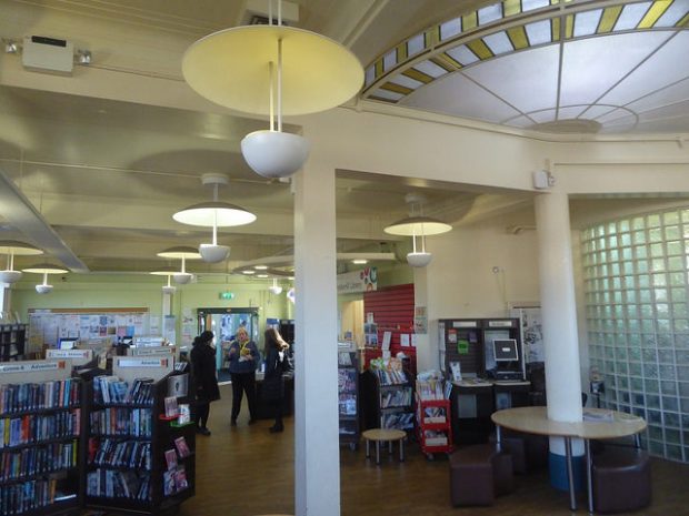 Photo of the inside of a library which has a semi circular skylight in the ceiling.