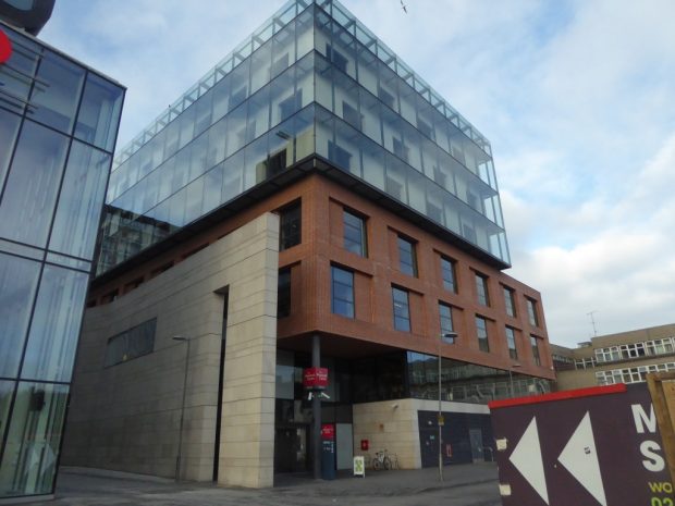 Photo of the outside of the Woolwich centre - a multi-storey glass and brick building