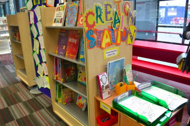 Photo of activity sheets, pencils and crayons in the library