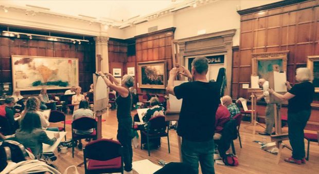 People participating in a life drawing class.