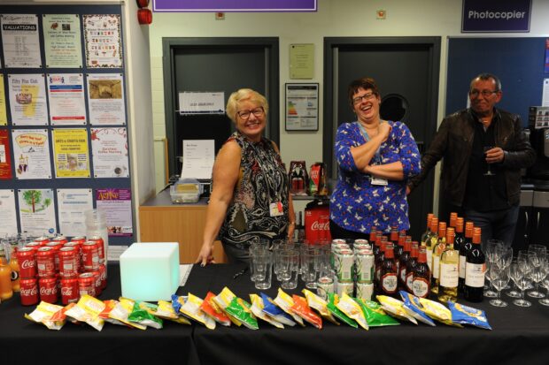 Photo of staff and volunteers ready to serve drinks and snacks.