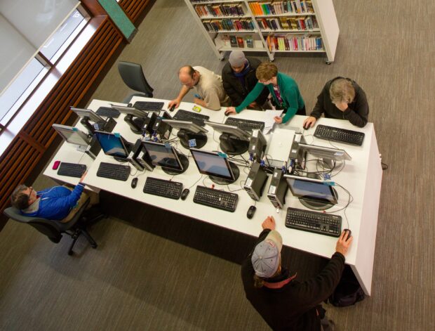 Aerial photo of people using computers in Exeter library