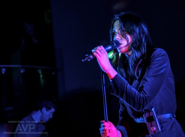 Photo of a female singing on stage.