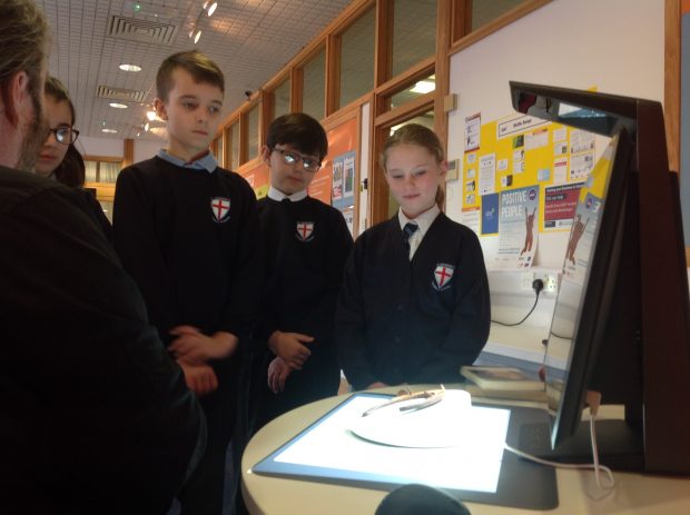 Photo of a group of school children scanning objects during the BBC Civilisations Project.