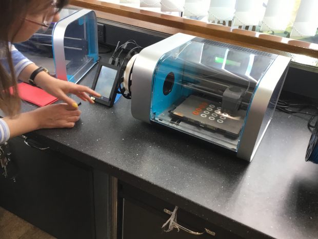 Photo of someone using the 3D printer