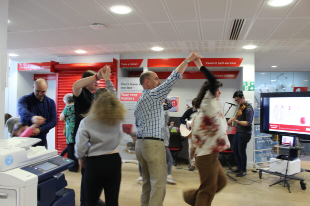 Photo of people dancing in a science ceilidh.