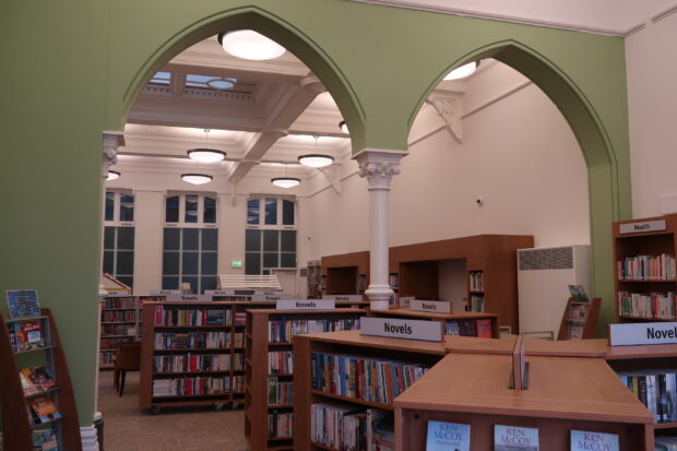 Photo of the inside of a room in the library with gothic arches and a decorated pillar