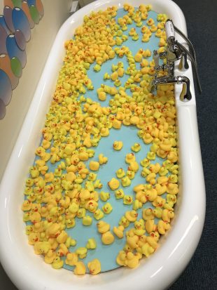 Photo of a release the Pressure exhibit, consisting of a bath full of yellow rubber ducks