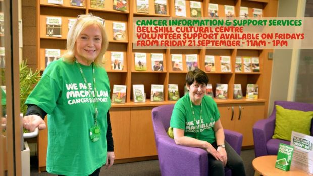 Photo of 2 women wearing macmillan green tshirts in a library