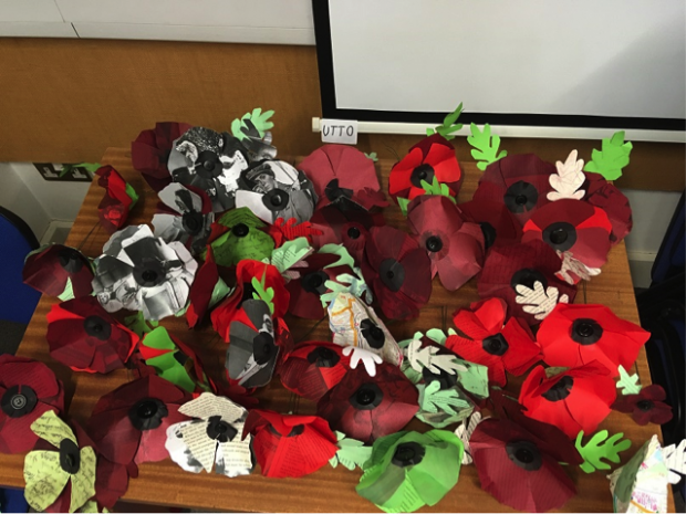 a pile of red handmade poppies