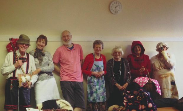 Photo of a row of older people dressed in 1940s period outfits