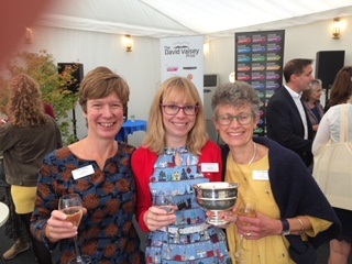 Photo of 3 women from Prestbury library holding a silver trophy