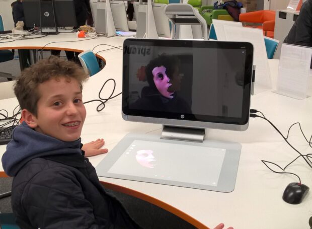 Young library visitor who has scanned his own face, using the HP Sprout.