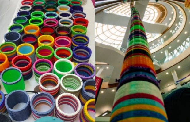 A photo of a table full of coloured discs and another photo where all the discs stacked on top of each other rising to the ceiling of the library