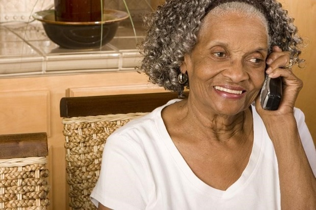 Smiling woman using the telephone