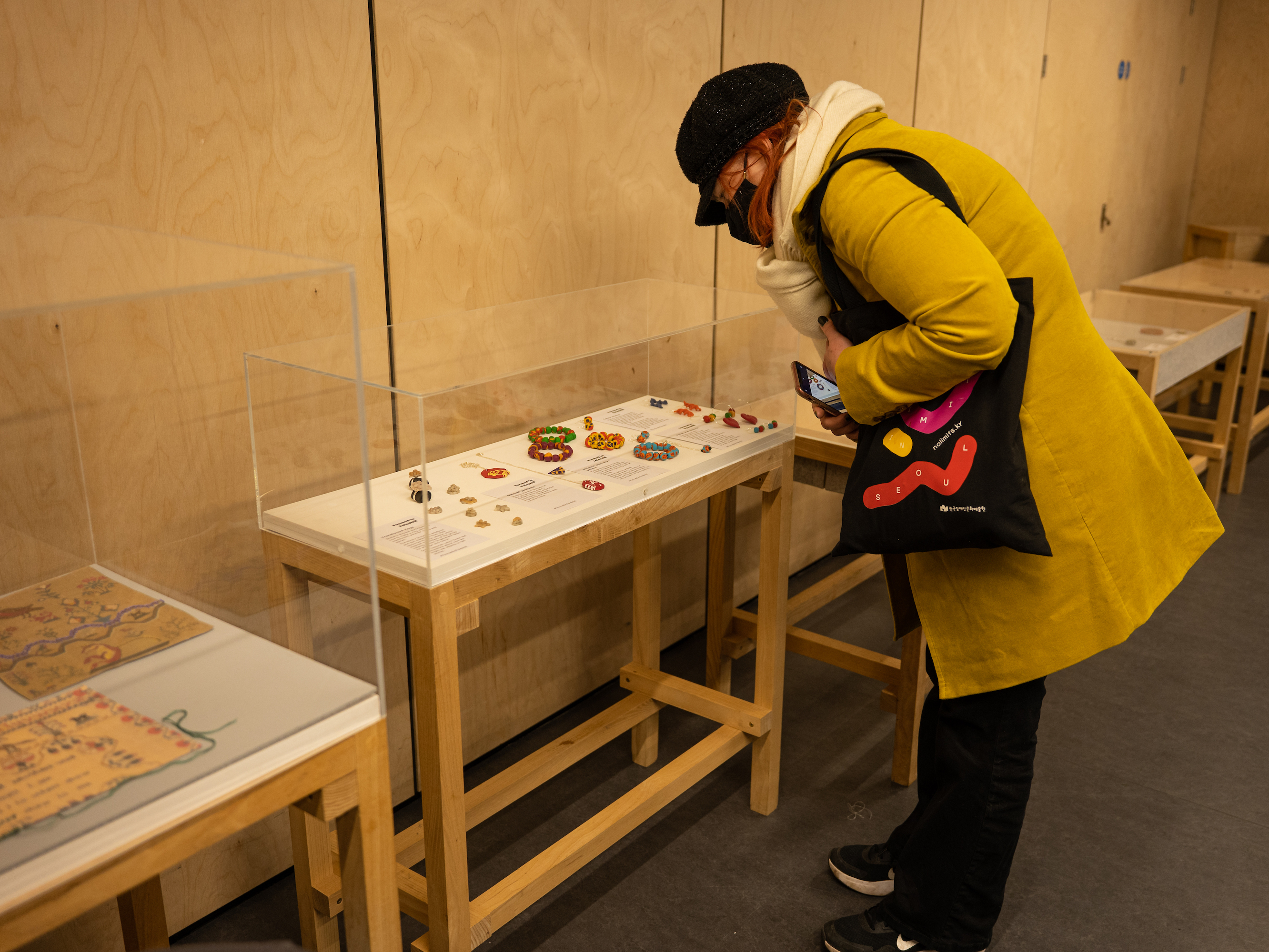 Person looking at exhibit items in a glass case